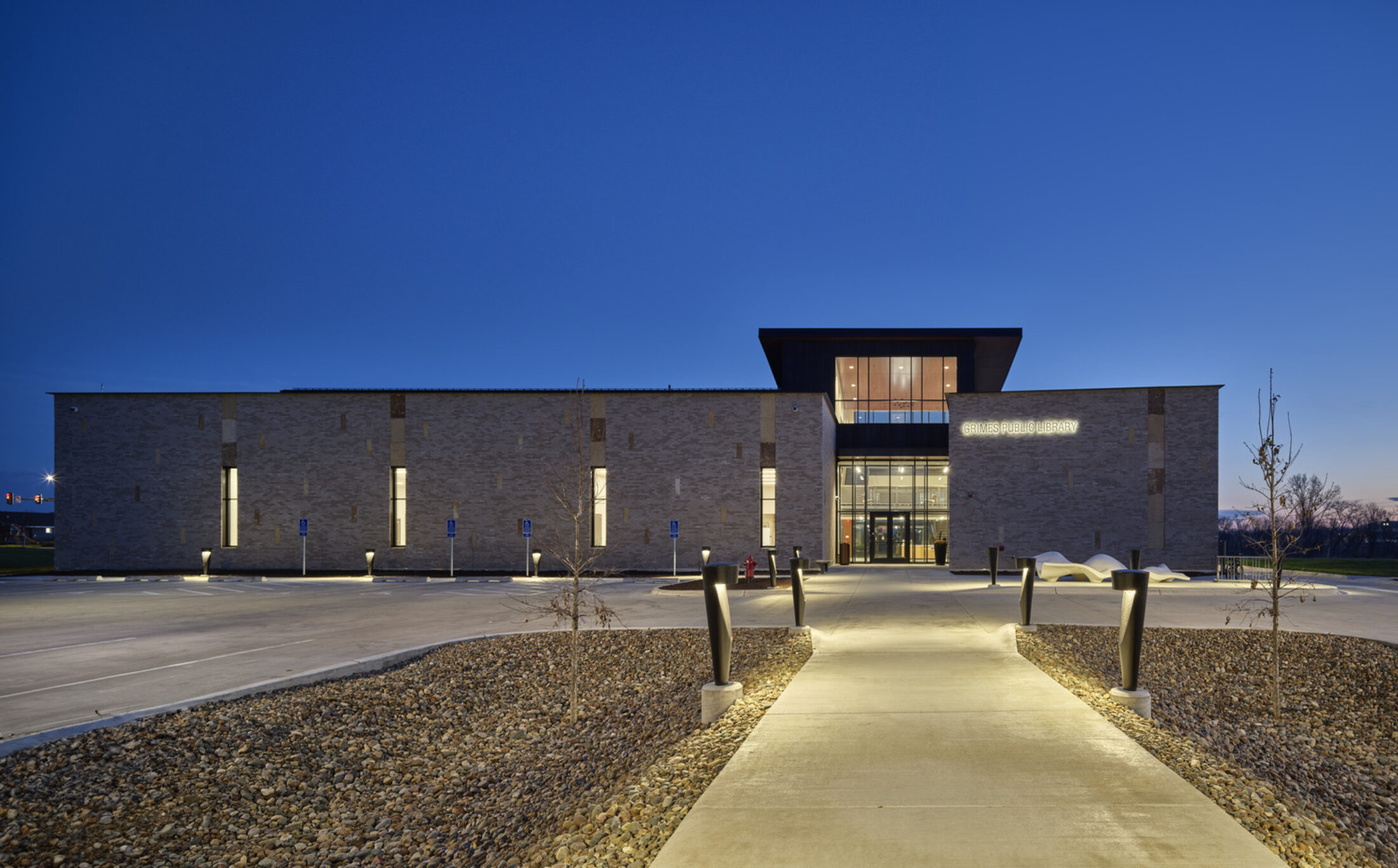 Modern building exterior at dusk, featuring concrete work by a Central Iowa Concrete Company.