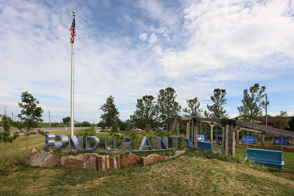 Bondurant, Iowa welcome sign with U.S. flag. Central Iowa concrete company serves this area.