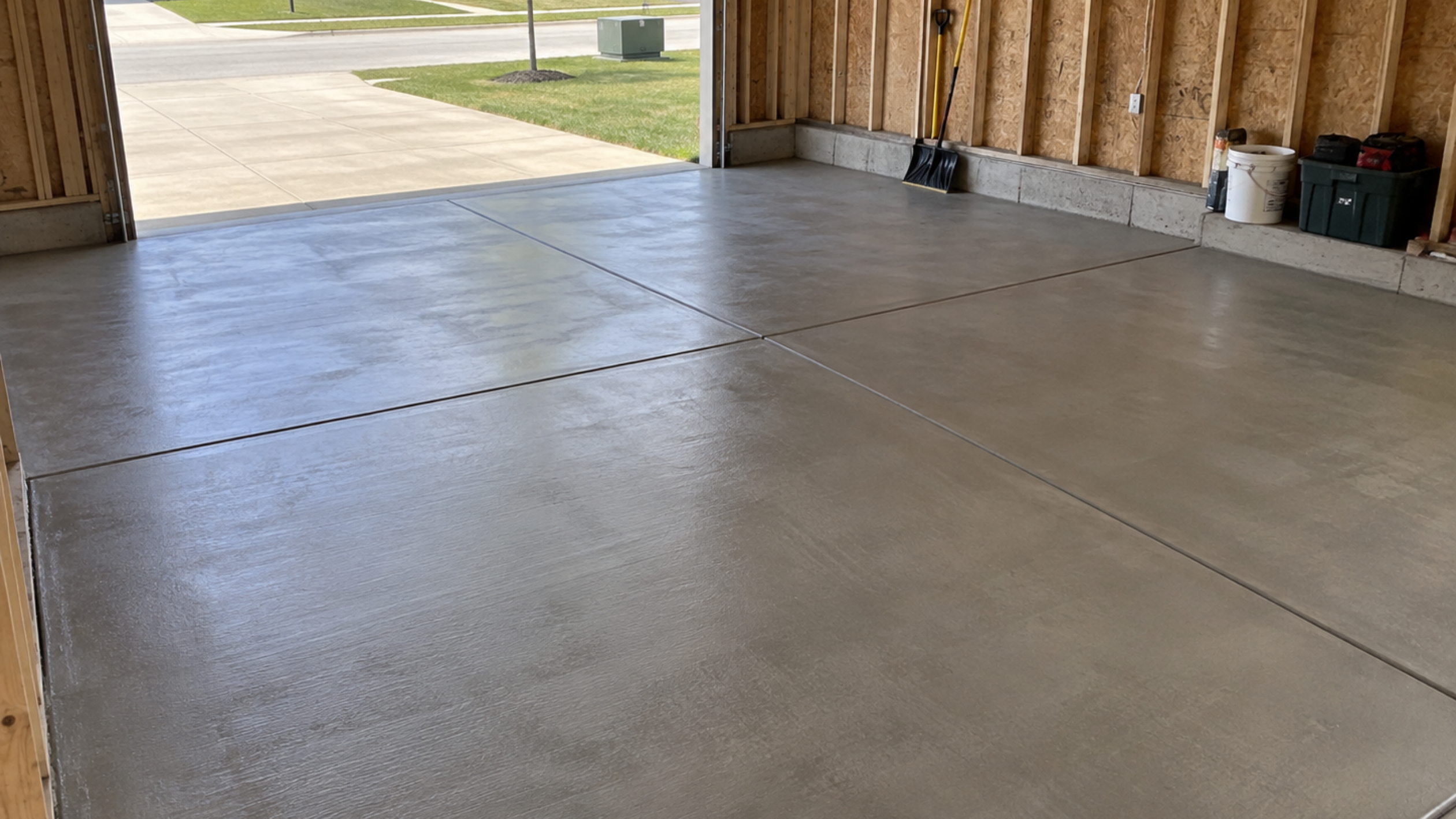 Newly poured concrete garage floor with expansion joints